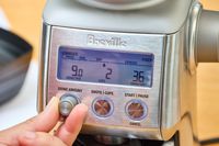 A person adjusts the grind amount on the Breville The Smart Grinder Pro
