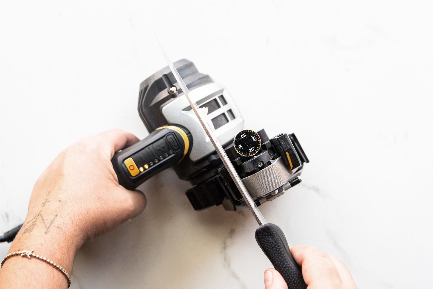 A person sharpening a knife using an electric knife sharpener