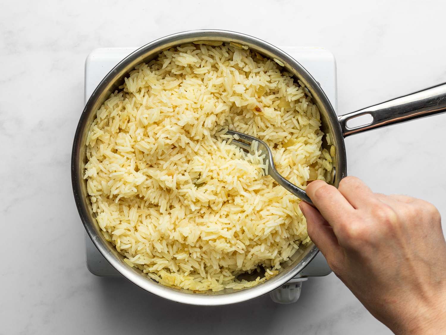 Rice fluffed inside saucepan 