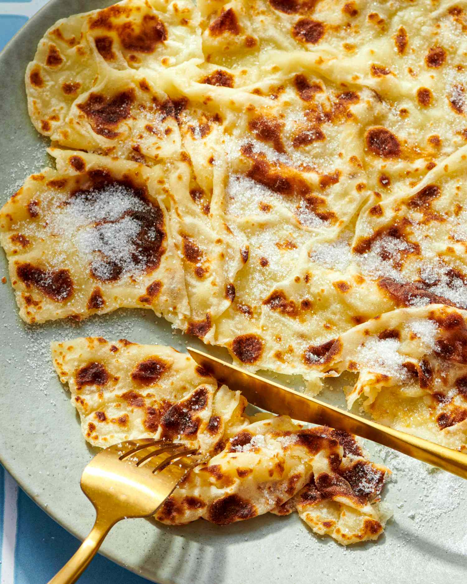 Plate of Norwegian lefse with golden silverware for serving