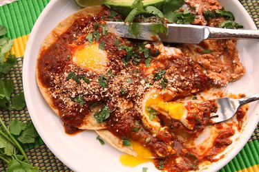 A plate of homemade huevos rancheros with tomato-chile salsa.
