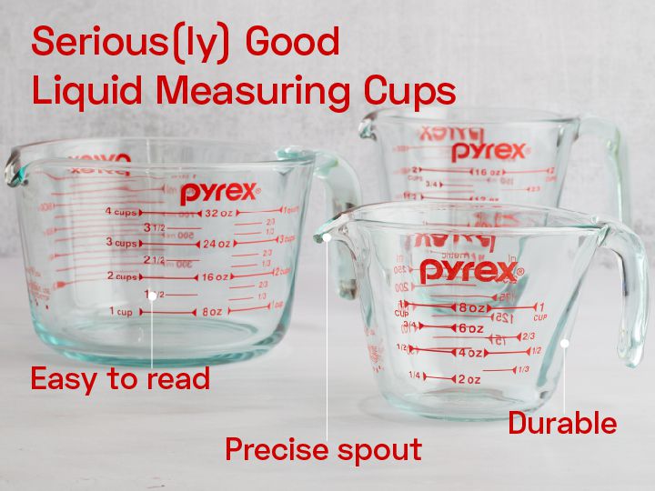 Three glass measuring cups on a marble countertop.