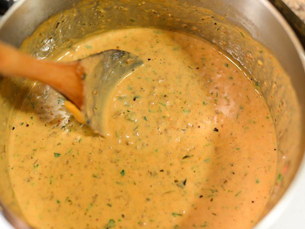 The finished taco queso dip in a saucepan, ready to transfer to serving bowls.