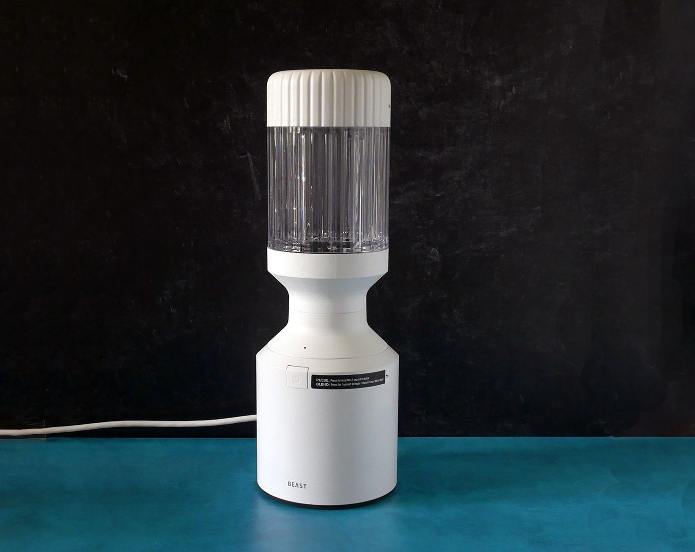 beast blender on blue countertop with black background