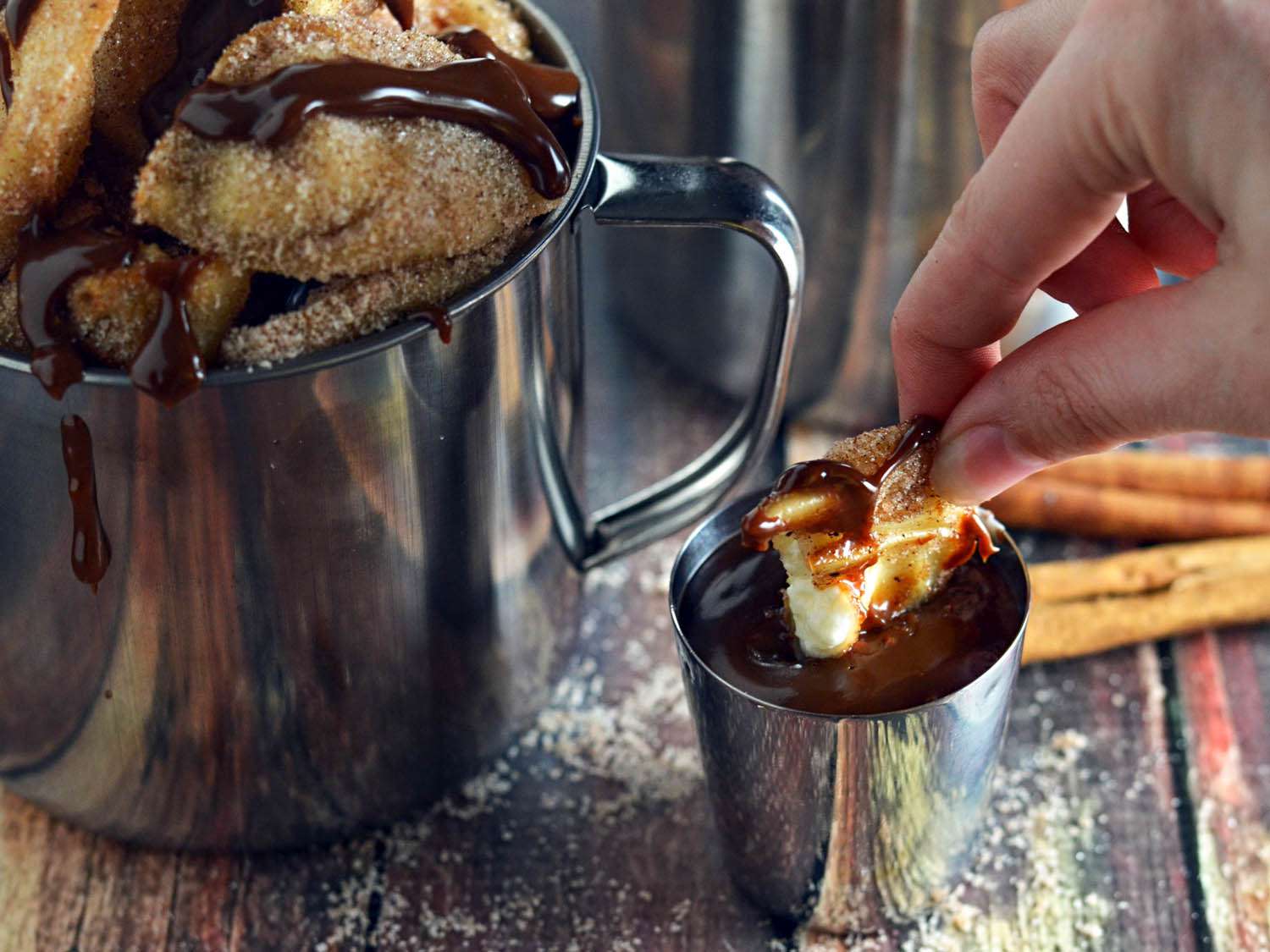 The author dips a cream cheese wonton into the Nutella sauce.