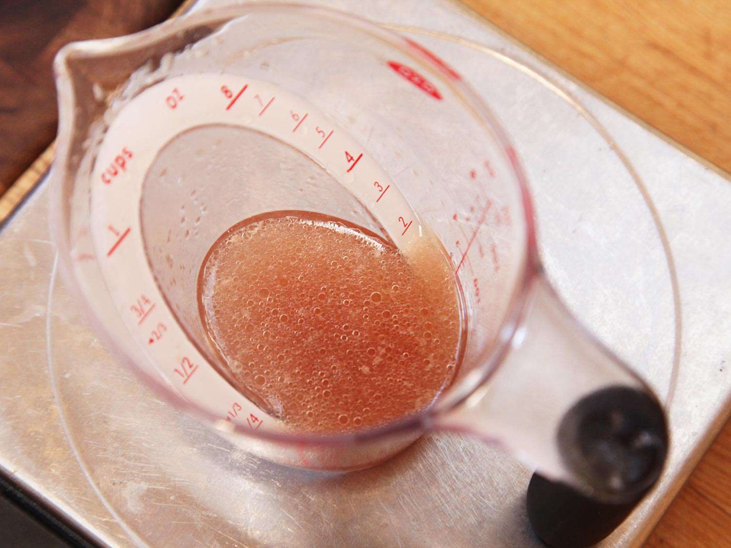 Droplets of fat on the surface of juices expressed from sous vide chicken breast.