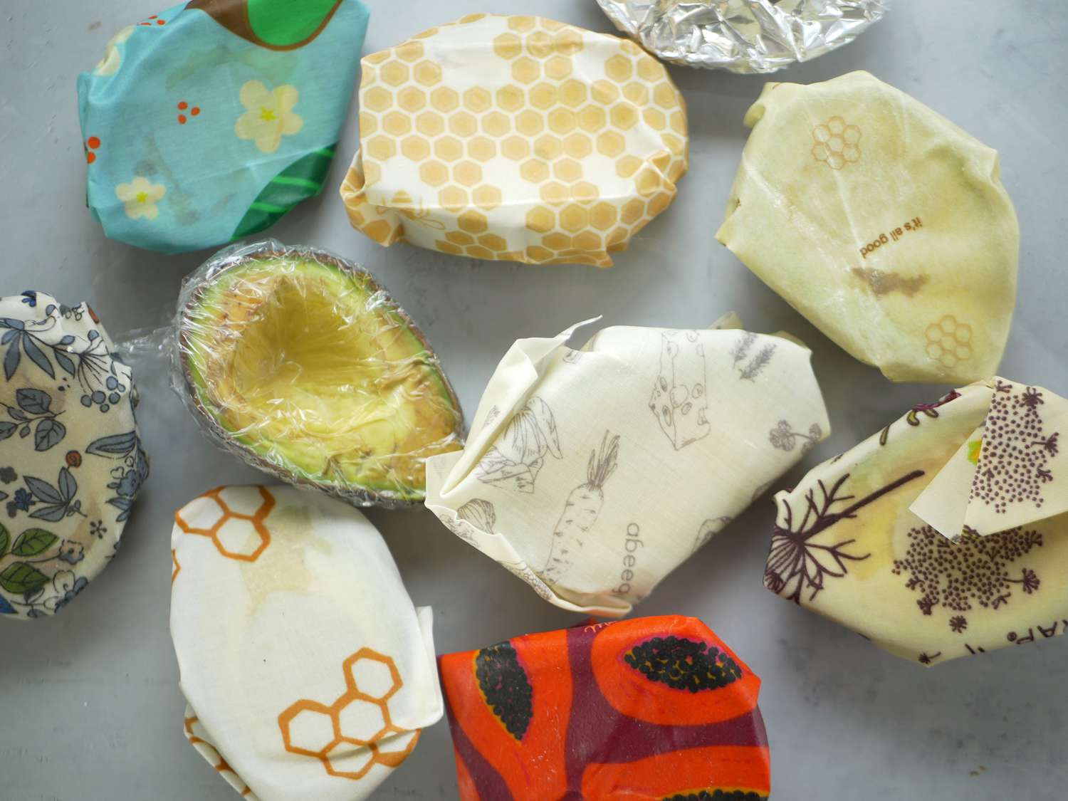 avocados wrapped in beeswax wrap and one with plastic wrap