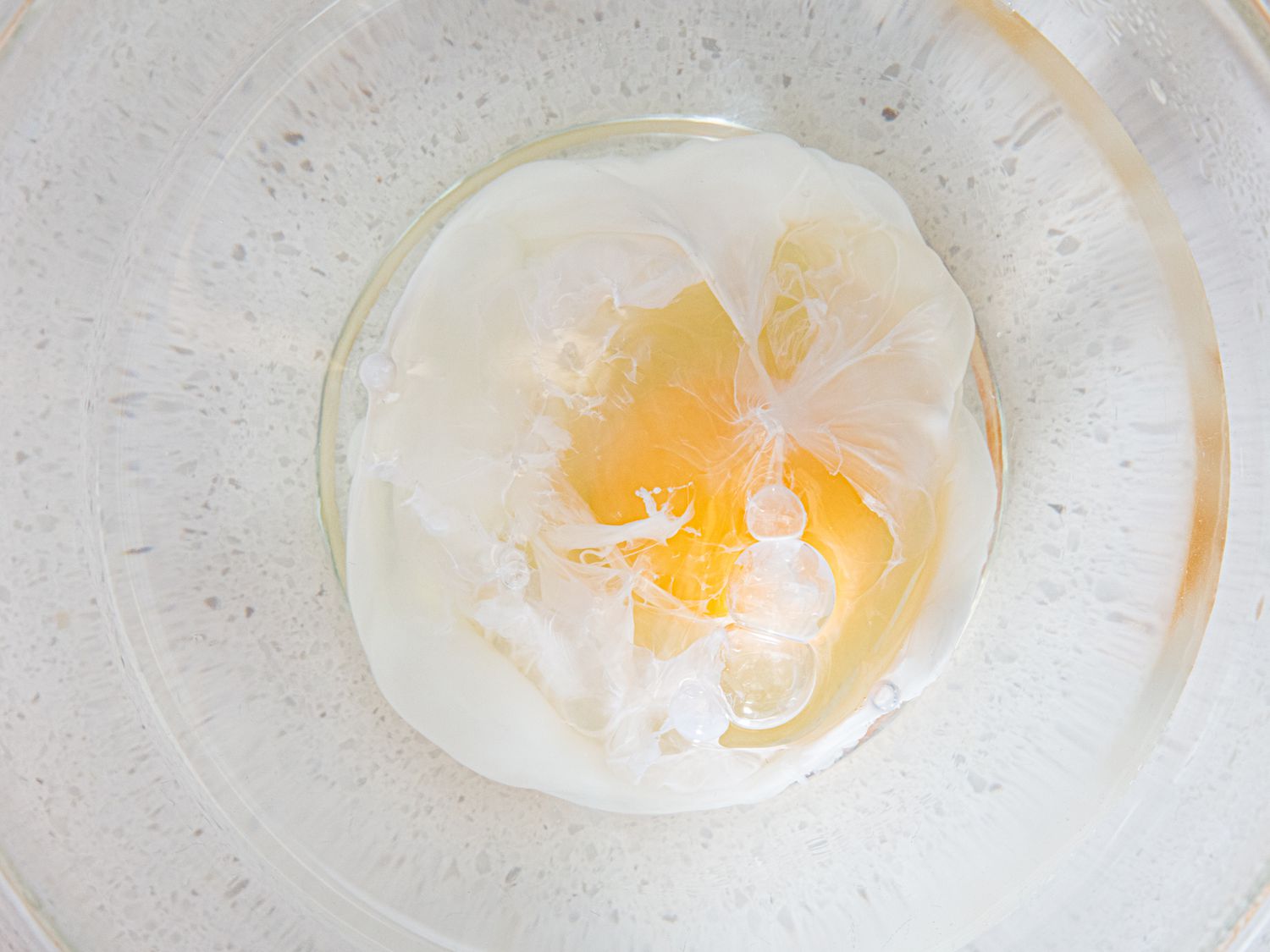 Overhead view of egg placed into mircowave