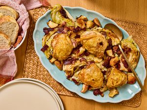 Sheet pan chicken thighs served with bacon and apple on a platter