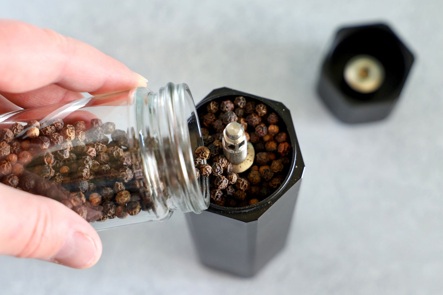Filling the Hexmill with peppercorns