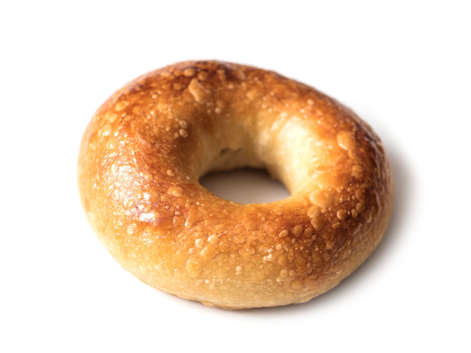 A bagel with a small ring and extensive blistering.