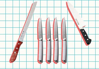 Assorted kitchen knives arranged on a grid backdrop