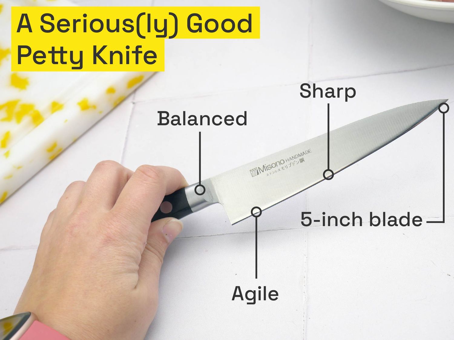 a person holding a petty knife