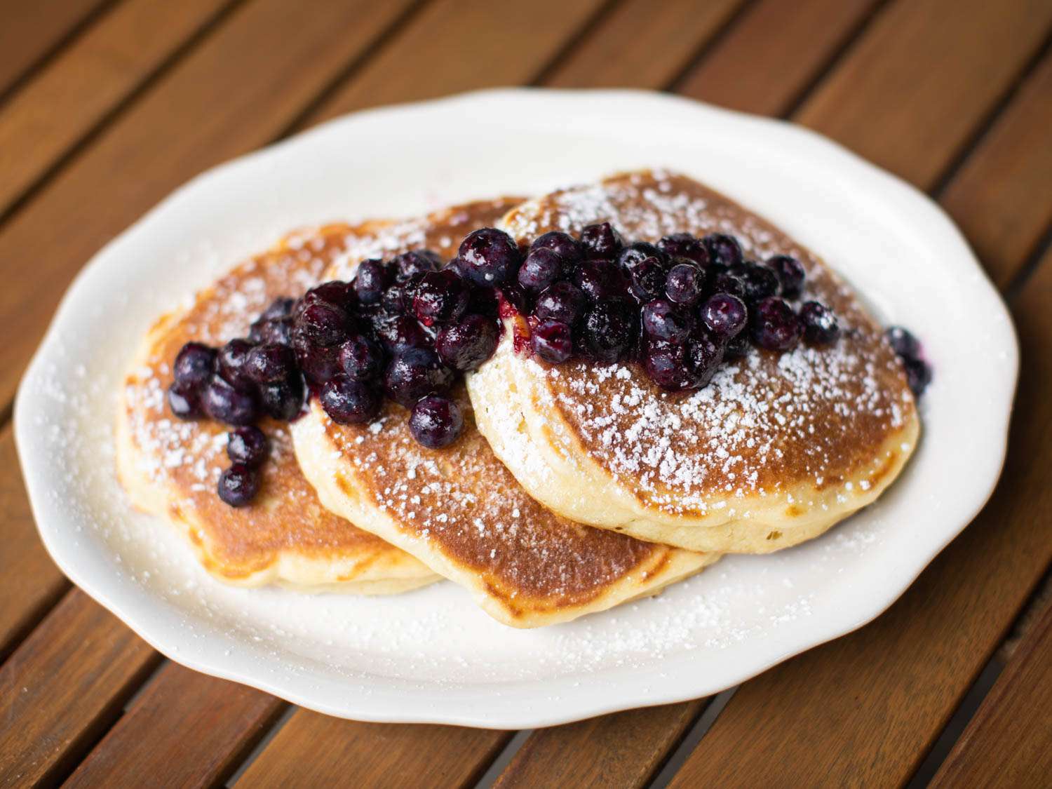 a plate of pancakes with blueberry topping at Bubby's