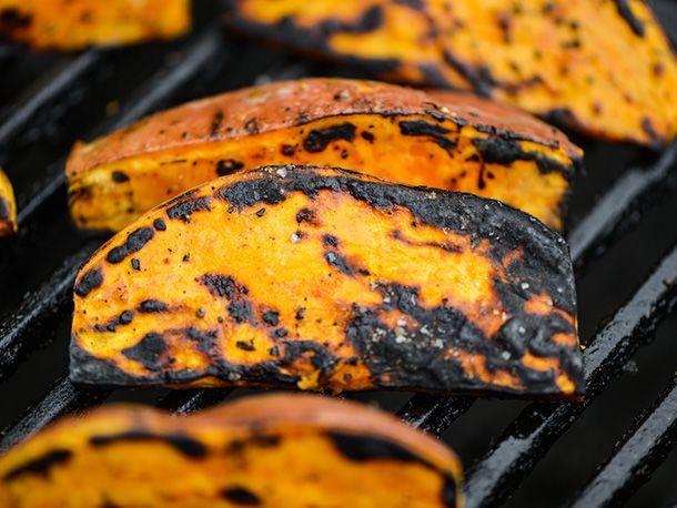 Sweet potato wedges on a grilling grate. 