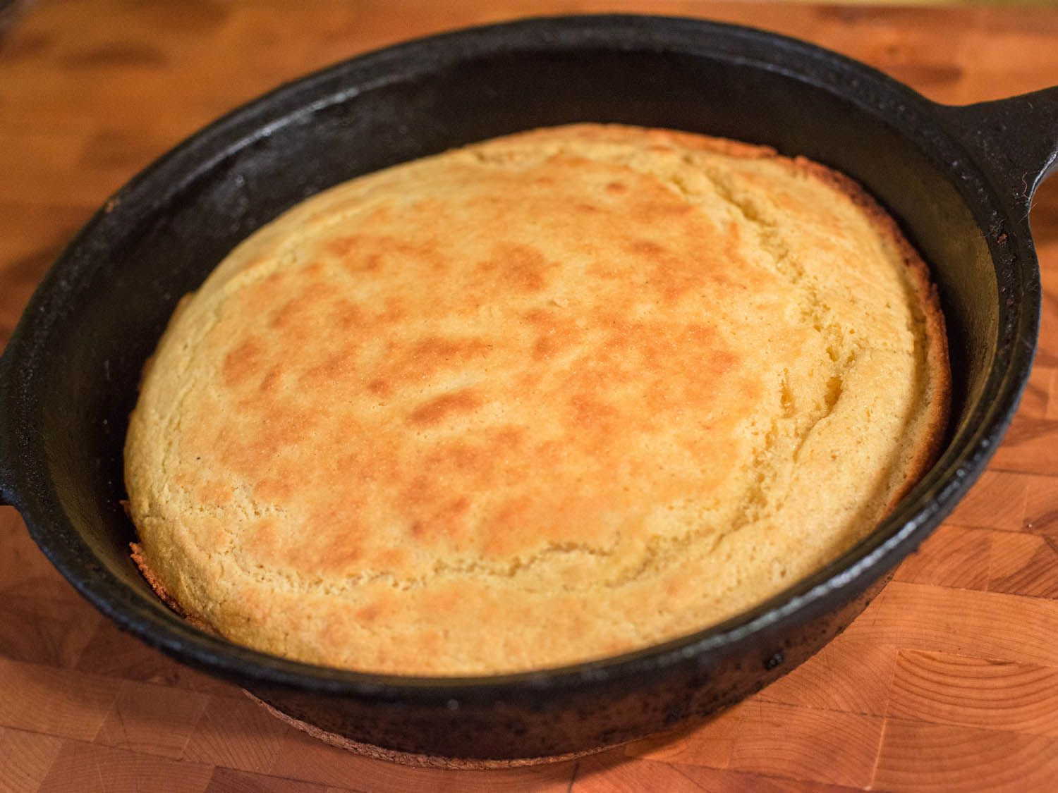 A cast iron skillet with golden brown cornbread.