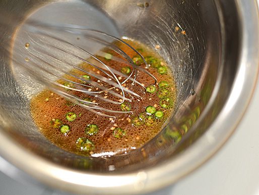 The dressing is whisked together in a prep bowl.