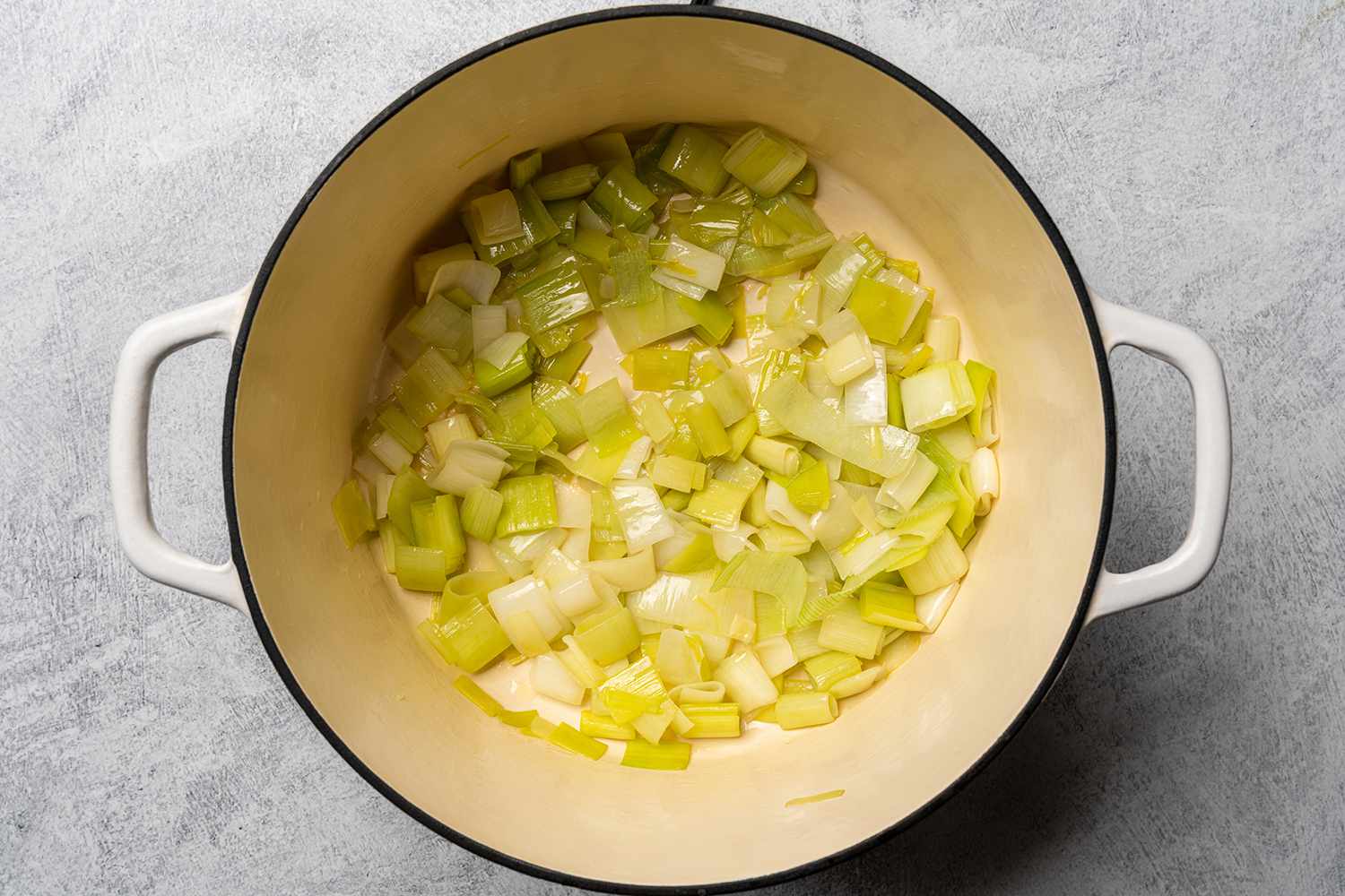 Chopped leeks cooking down in butter.
