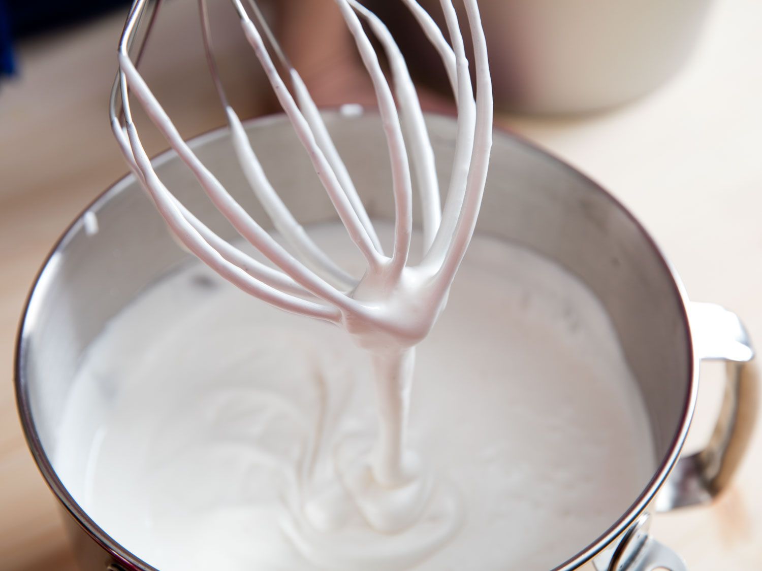 Meringue whipped soft enough to run off the wires, but thick enough to mound up on itself like soft-serve in the bowl.