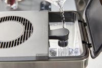 Water being poured into the Oxo Brew 8-Cup Coffee Maker's water tank