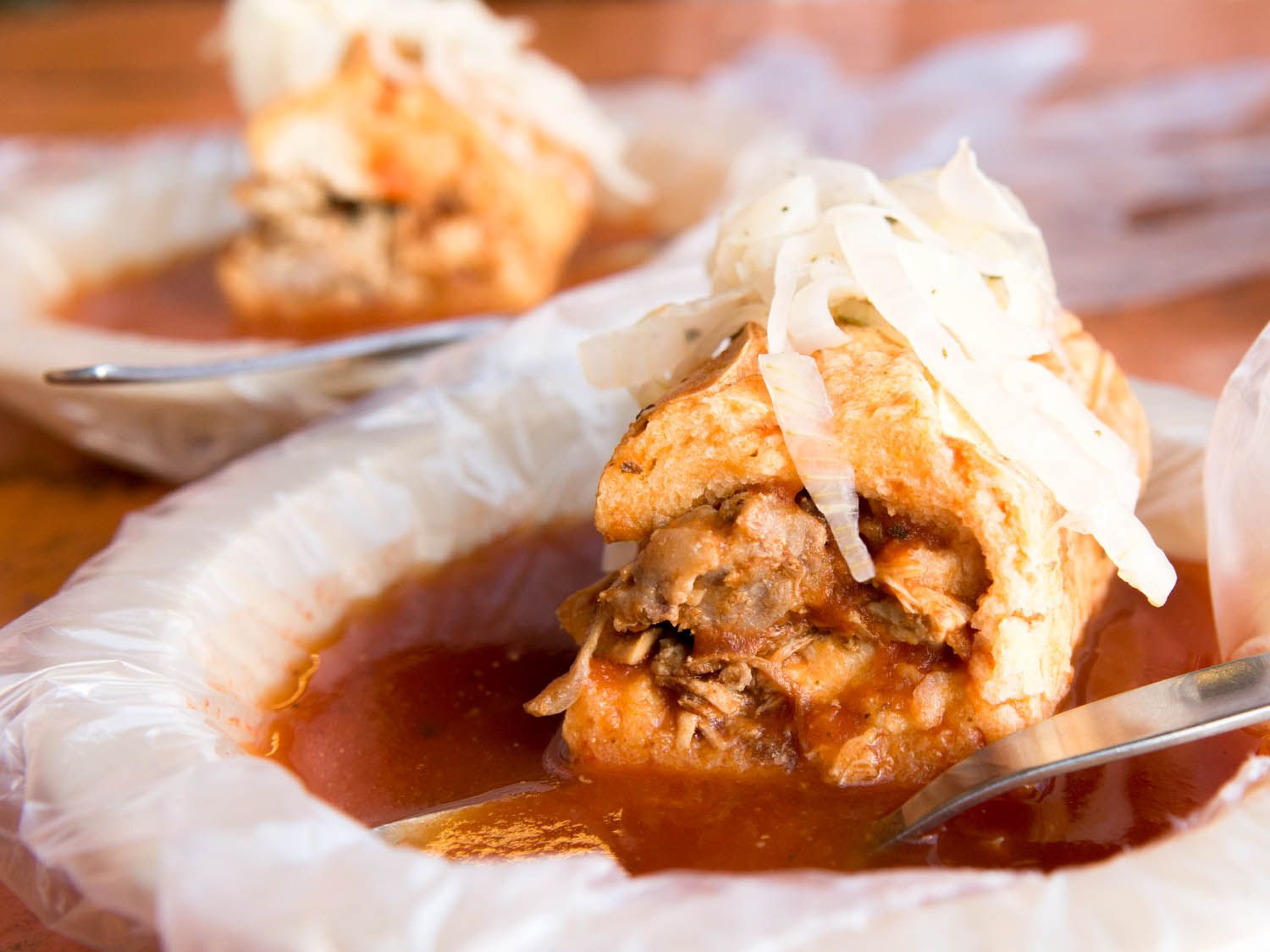 torta ahogada served in a pool of sauce