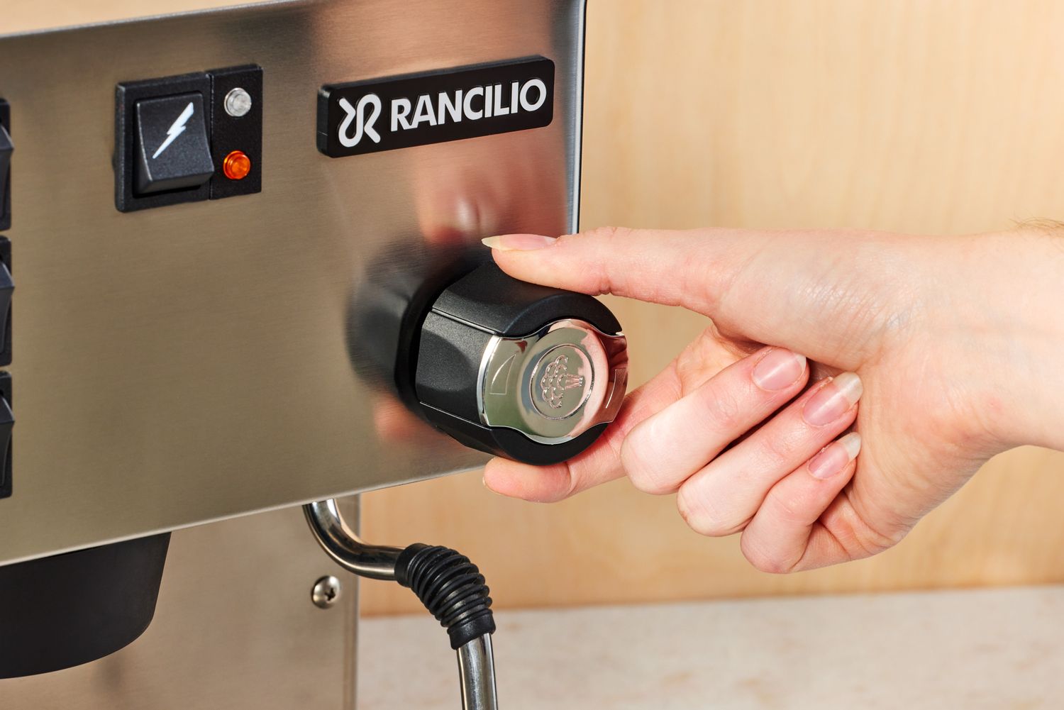 Closeup of a person turning a knob on the Rancilio Silvia Espresso Machine
