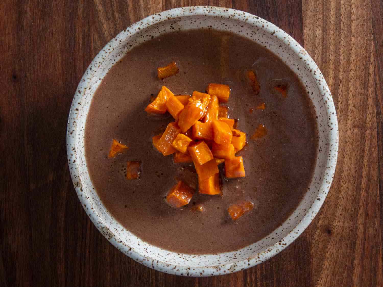 Overhead shot of a bowl of Cherokee pureed nut soup with sweet potato.