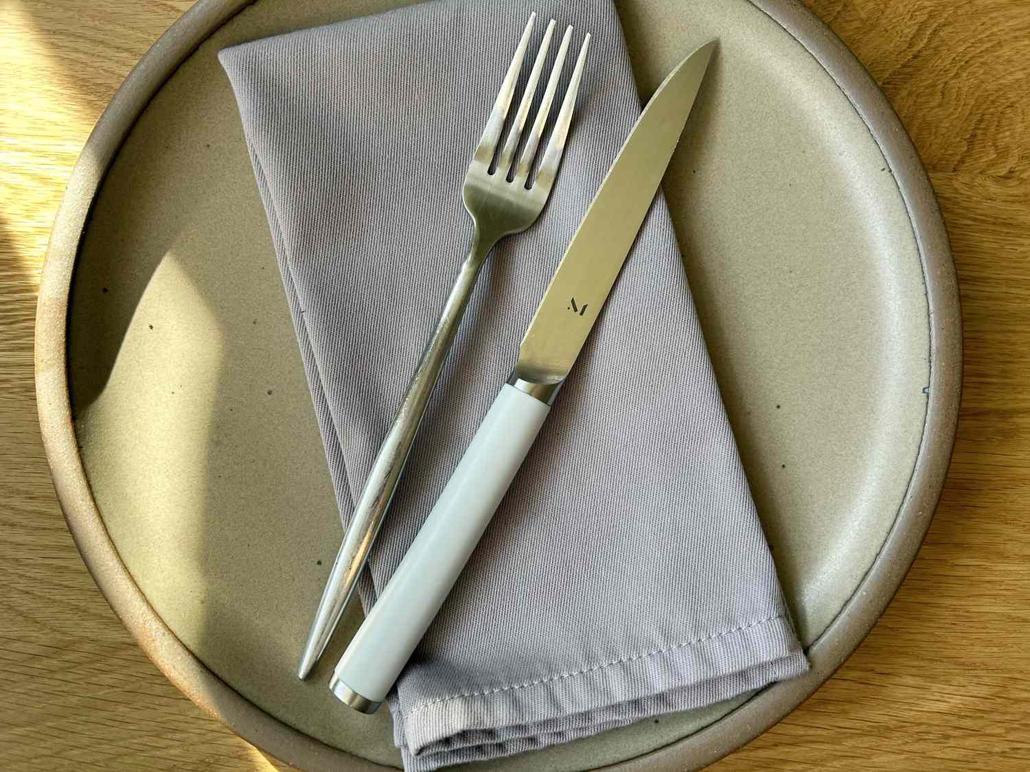 A set of flatware on a purple napkin