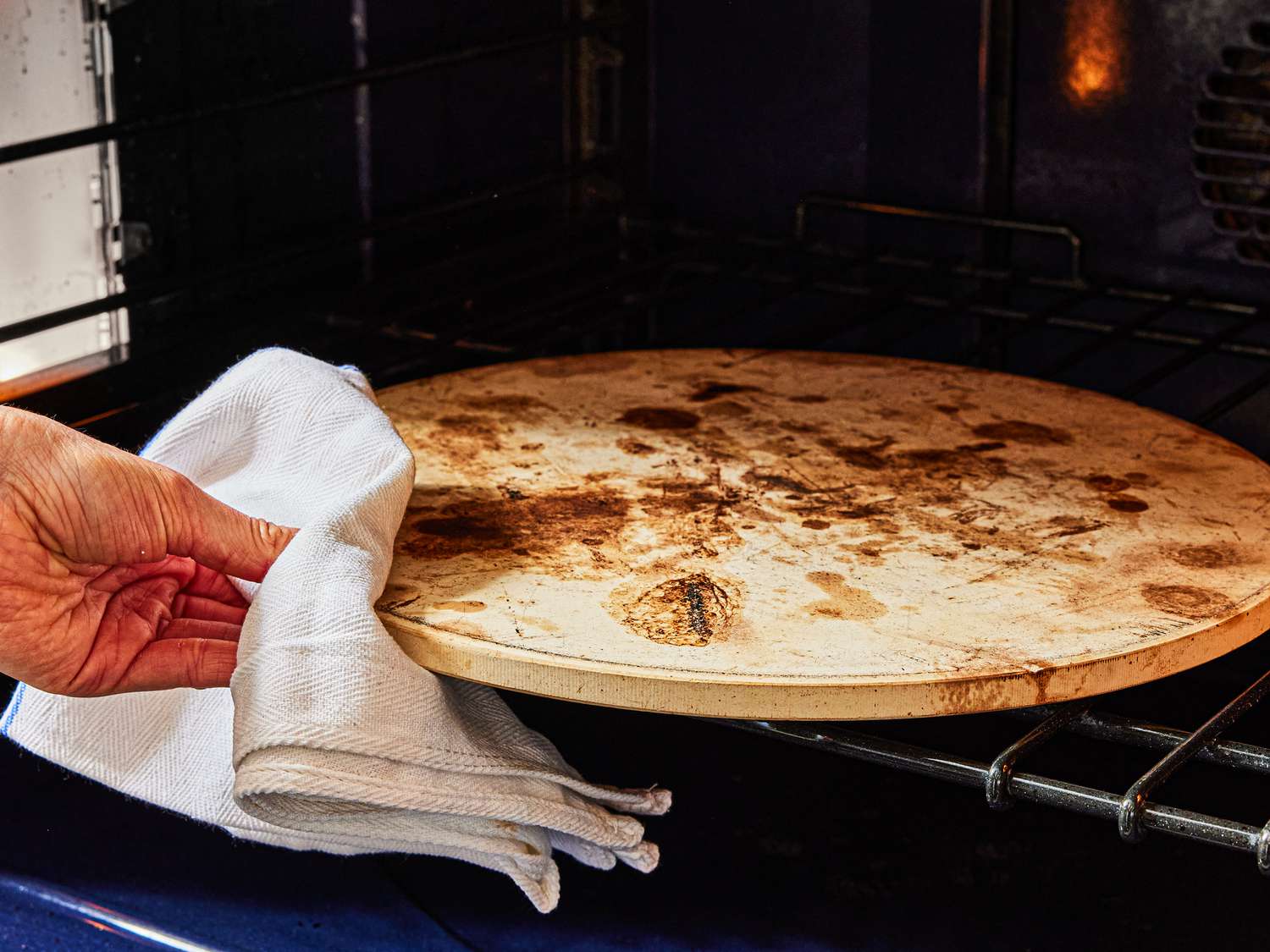 Baking stone being placed into an oven