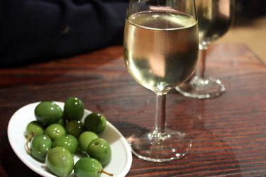 Green olives served with glasses of sherry