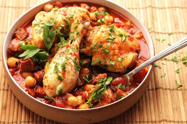 30-minute pressure cooker chicken with chickpeas, tomatoes, and chorizo, served in a shallow serving bowl.
