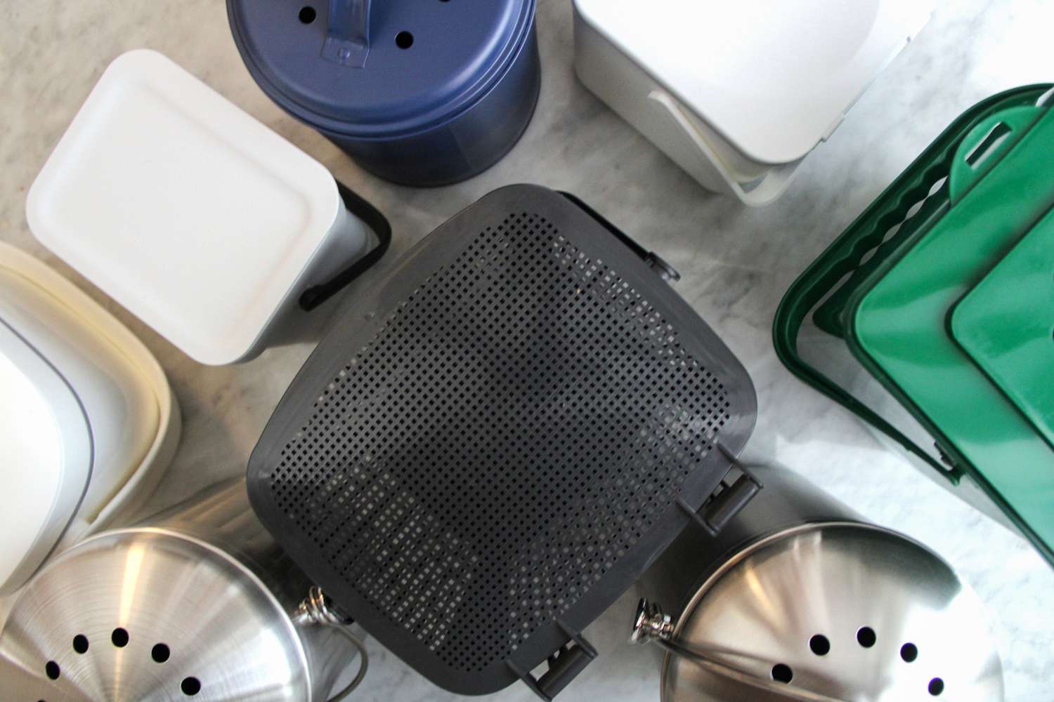 A variety of food waste compost bins with lids and filters viewed from above