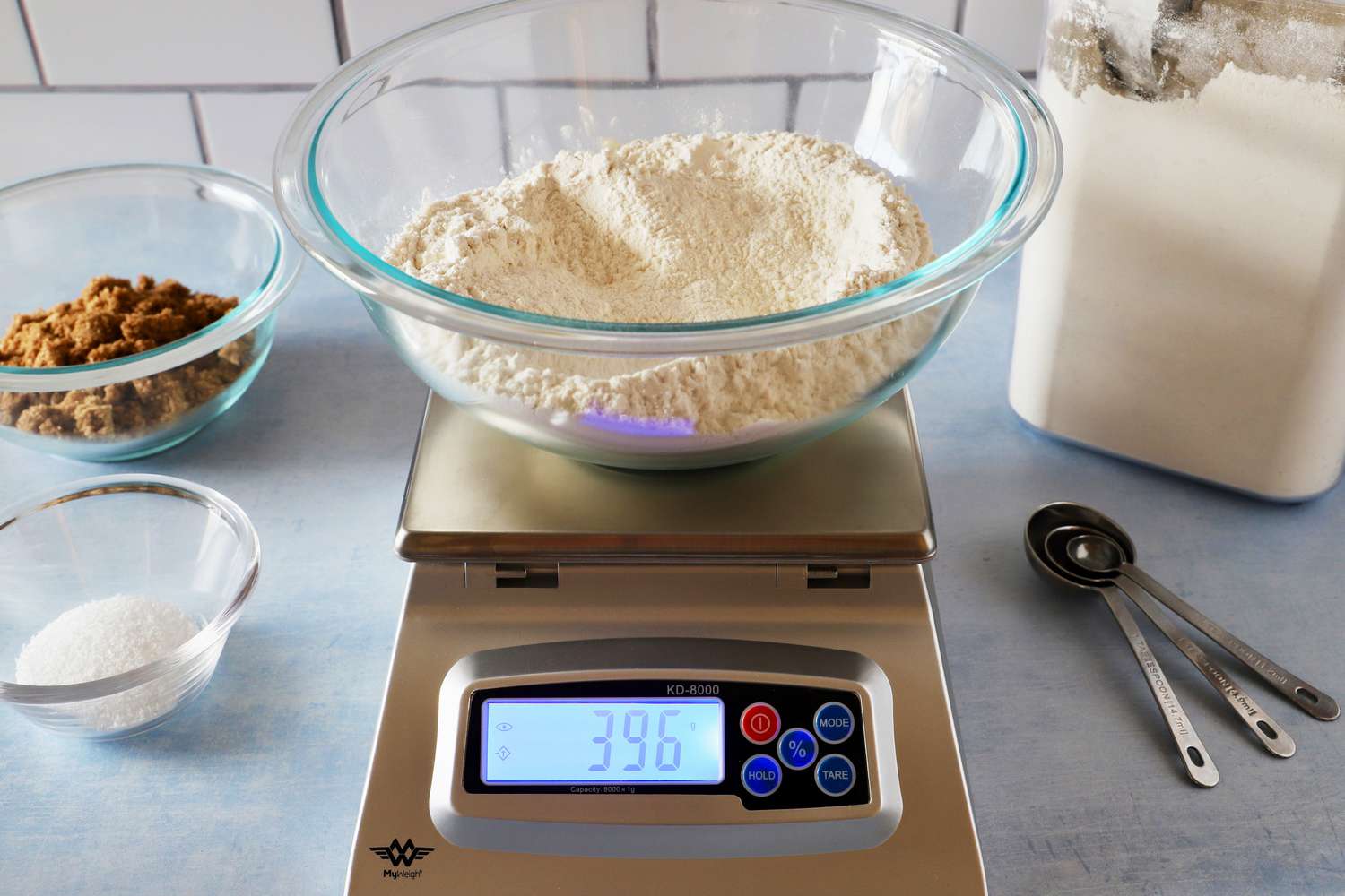 A bowl of flour on a kitchen scale
