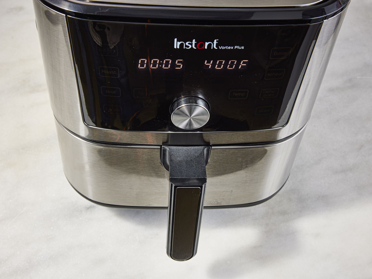 An air-fryer is preheated to 400 degrees Fahrenheit.