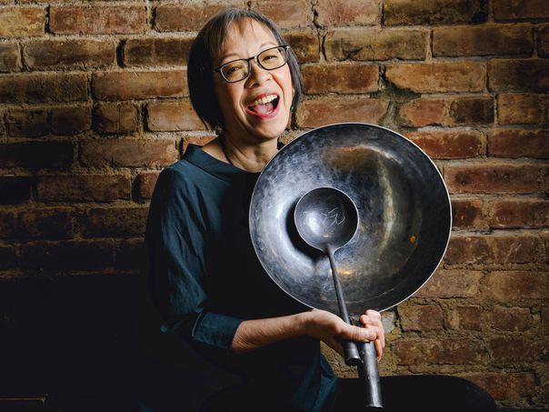 Grace Young posing with a wok 