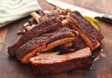 A photo of a pile of Sous Vide Barbecue Pork Ribs on a cutting board