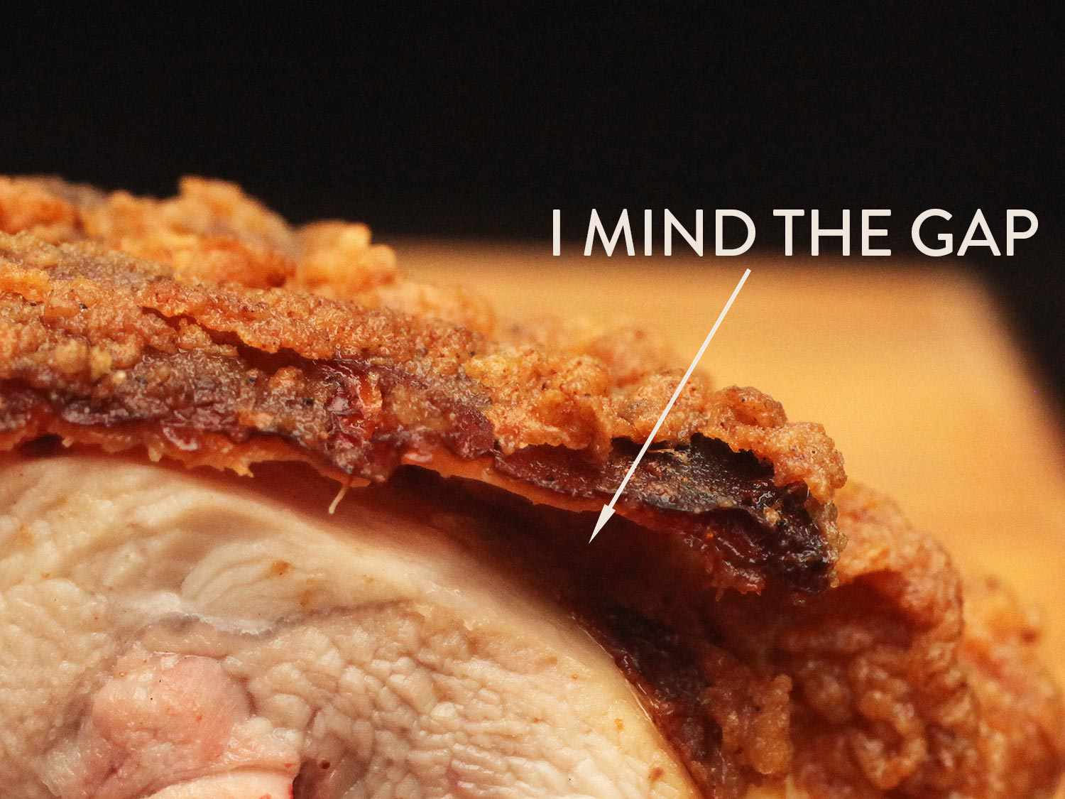 Cross section of a piece of fried chicken with air pocket between the meat and breading