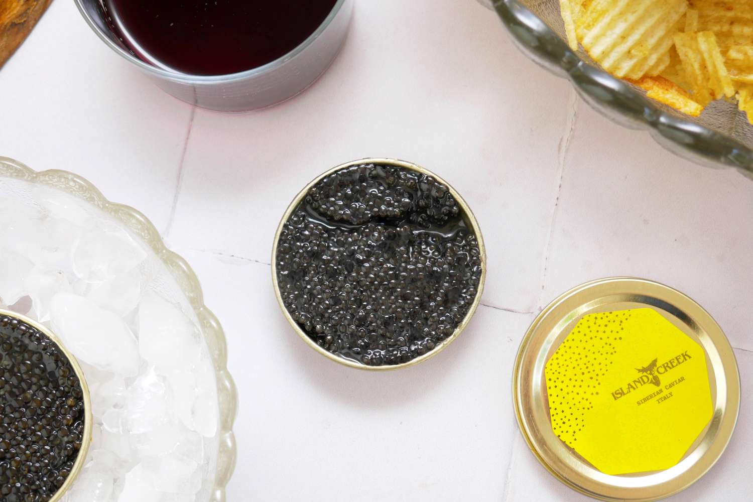 Island Creek Caviar on White Table With Chips and Ice Bowl