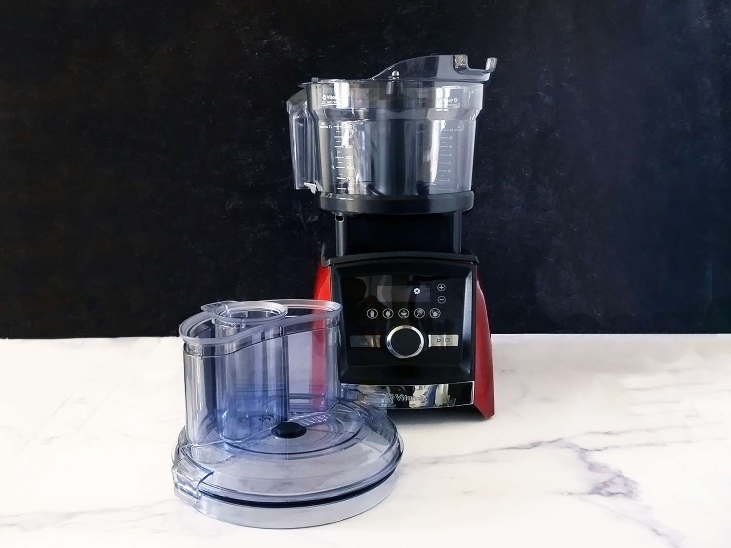 vitamix food processor and blender base with the lid on the marble counter
