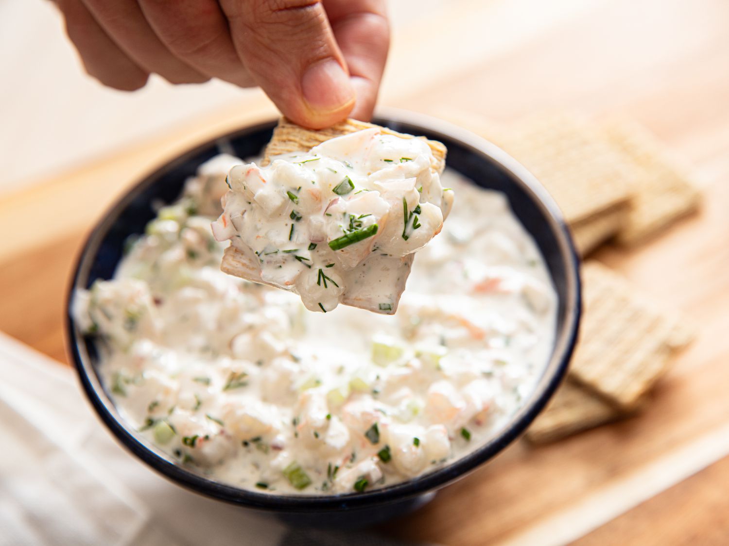 Shrimp dip on a cracker.