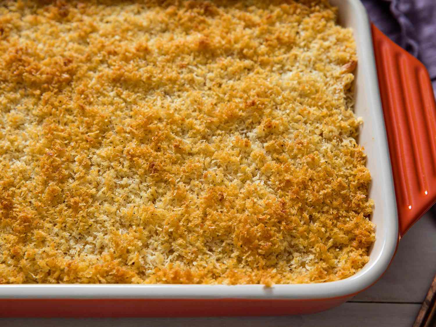 A casserole dish of baked macaroni and cheese with a breadcrumb topping.