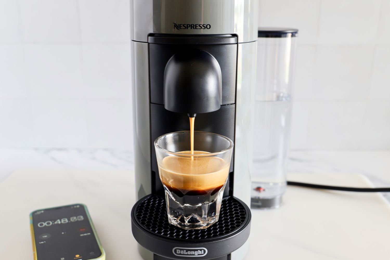 The Nespresso VertuoPlus Coffee and Espresso Machine by De'Longhi dispensing espresso into a cup