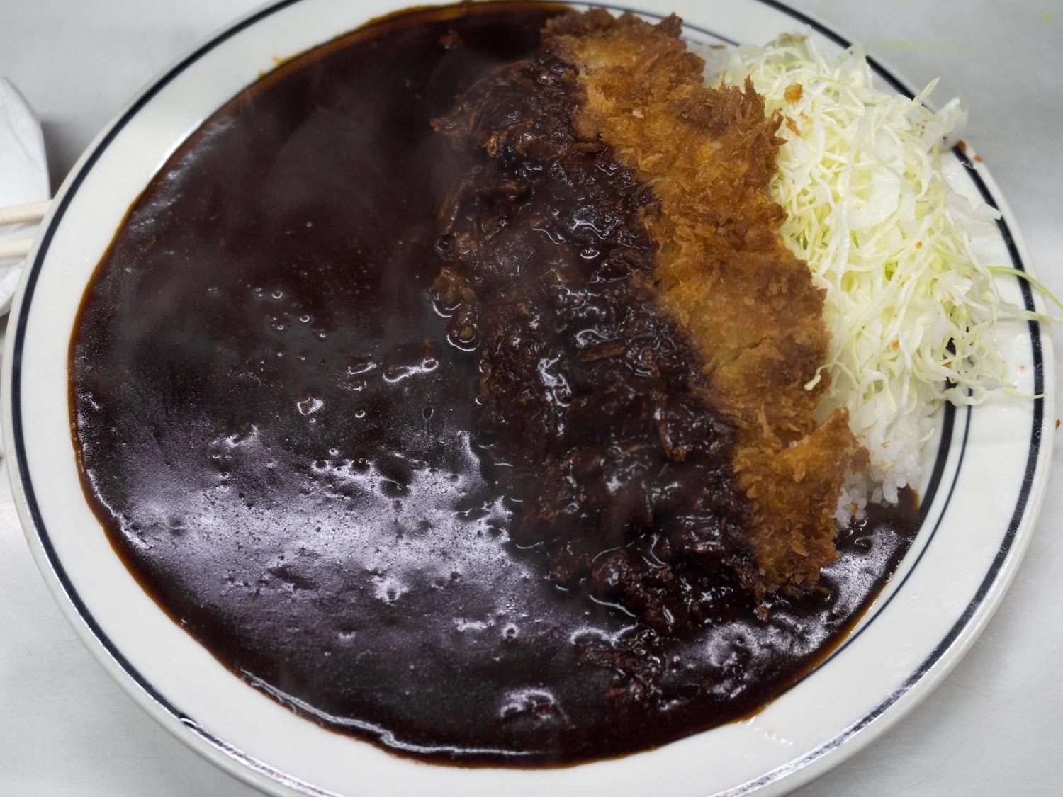Fried pork kare on a white plate from Kitchen Nankai in Jinbocho, Tokyo.