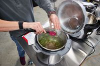 Person placing food in the Instant Pot Duo Plus 8-Quart Multi-Use Pressure Cooker V4