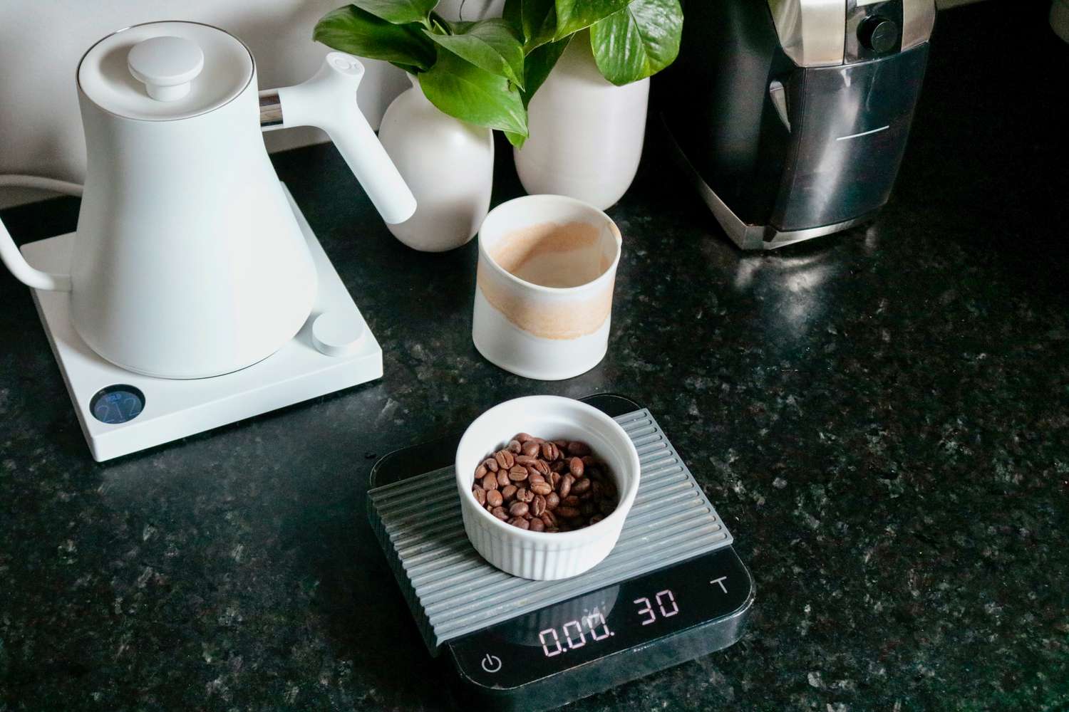 Coffee beans sitting in a dish on a scale