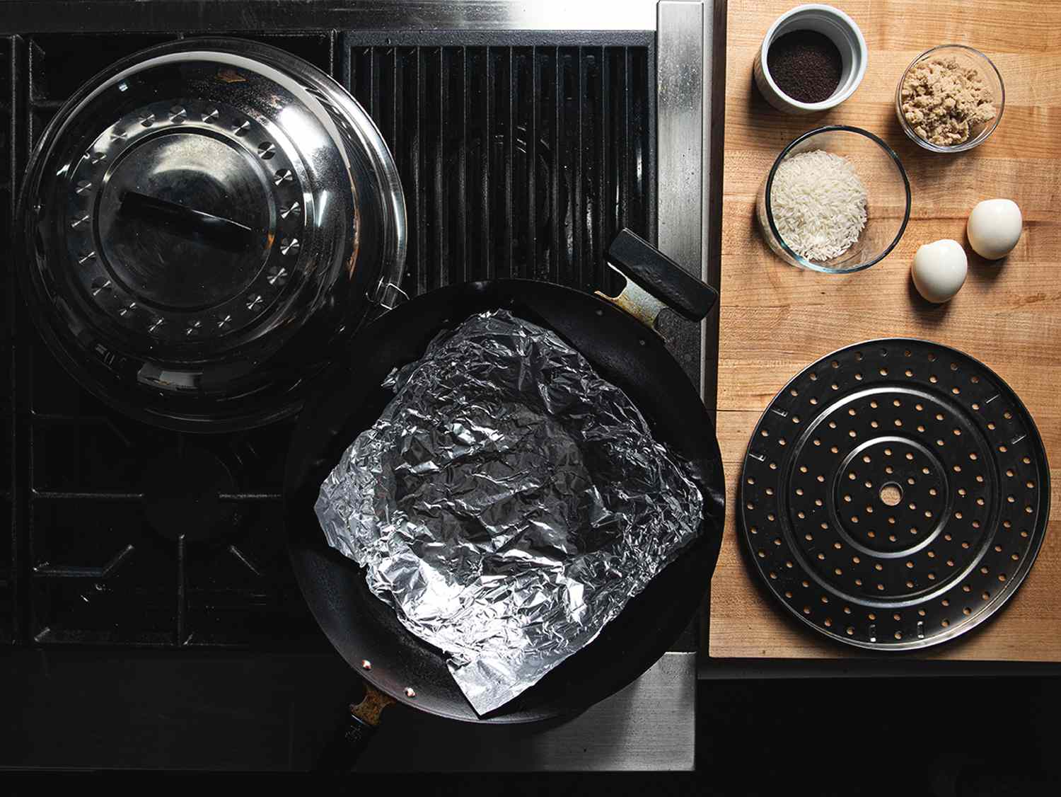 Overhead view of a wok station set up for smoking eggs.
