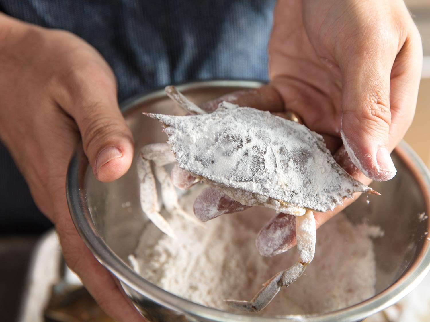 Dredging soft shell crabs in flour.