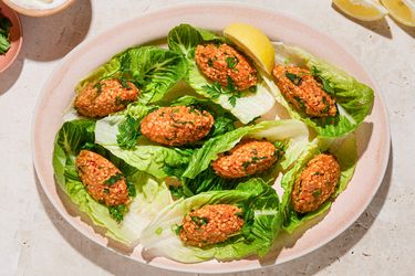 Turkish lentil koftes served on lettuce leaves with lemon wedges