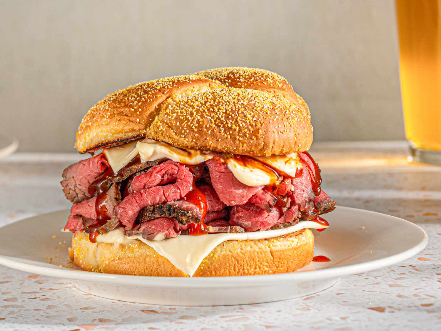 Sideview of a piled high roast beef sandwich.