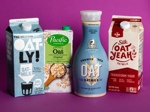 Four cartons of oatmilk from different brands.